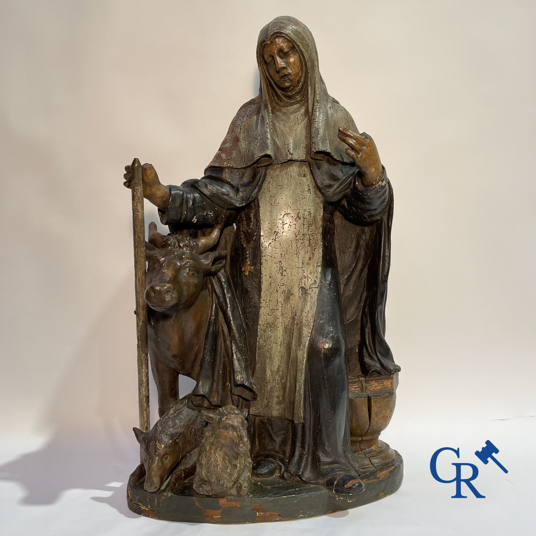 Imposing 17th century polychrome wooden statue of a Saint accompanied by a cow, a pig and a sheep.