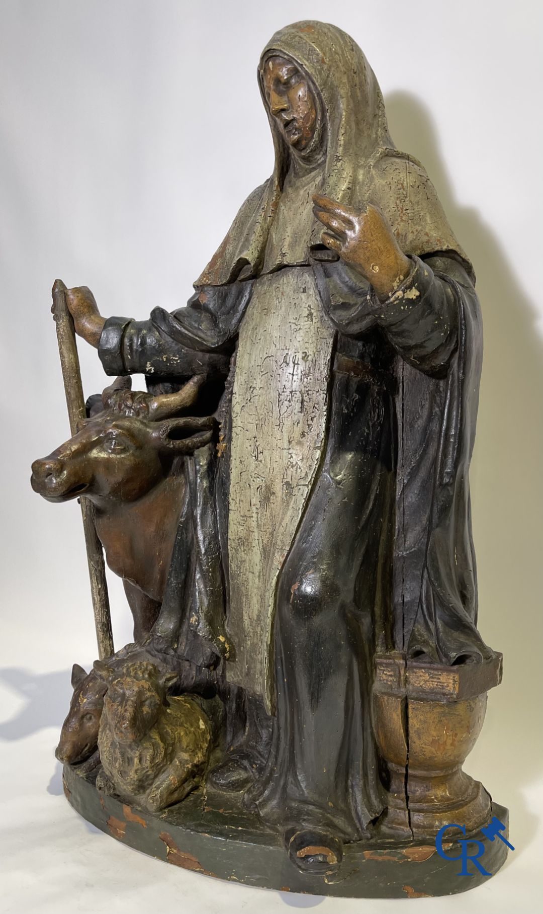 Imposing 17th century polychrome wooden statue of a Saint accompanied by a cow, a pig and a sheep.