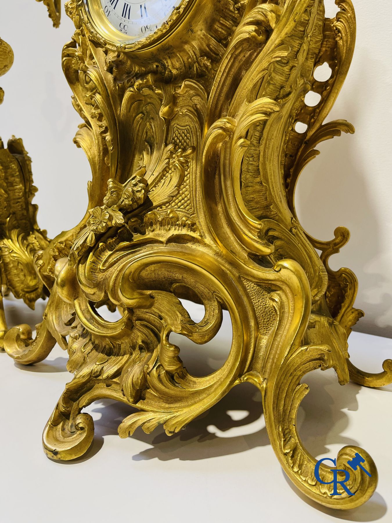 A large 3-piece fire-gilded bronze chimney set in LV style. 19th century.