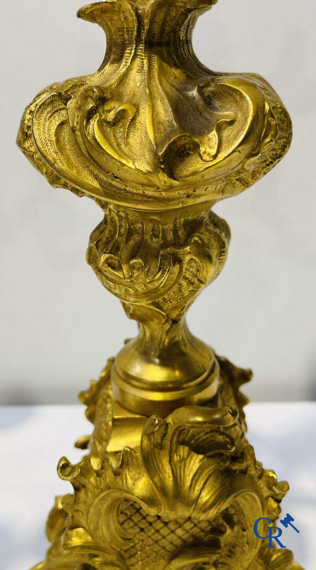 A large 3-piece fire-gilded bronze chimney set in LV style. 19th century.