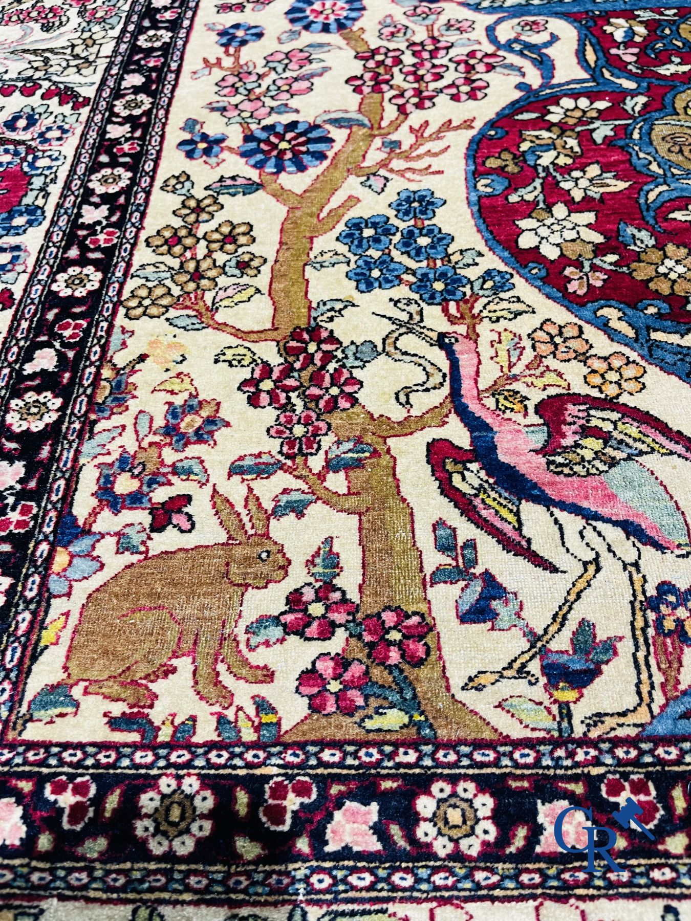 Oriental carpets. Iran. Persian carpet with a flower vase, birds and rabbits in a floral decor.
