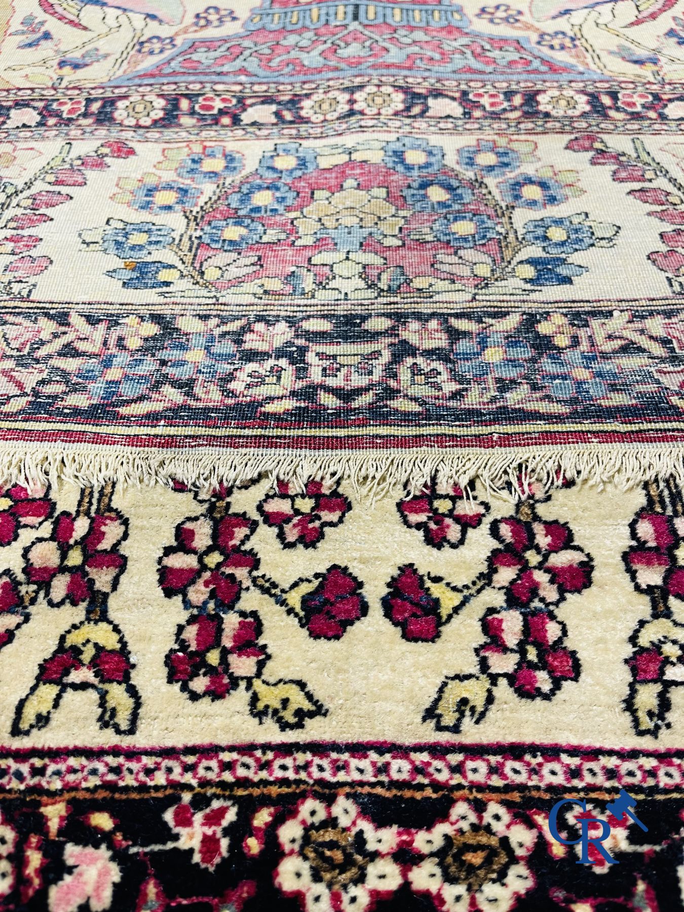 Oriental carpets. Iran. Persian carpet with a flower vase, birds and rabbits in a floral decor.