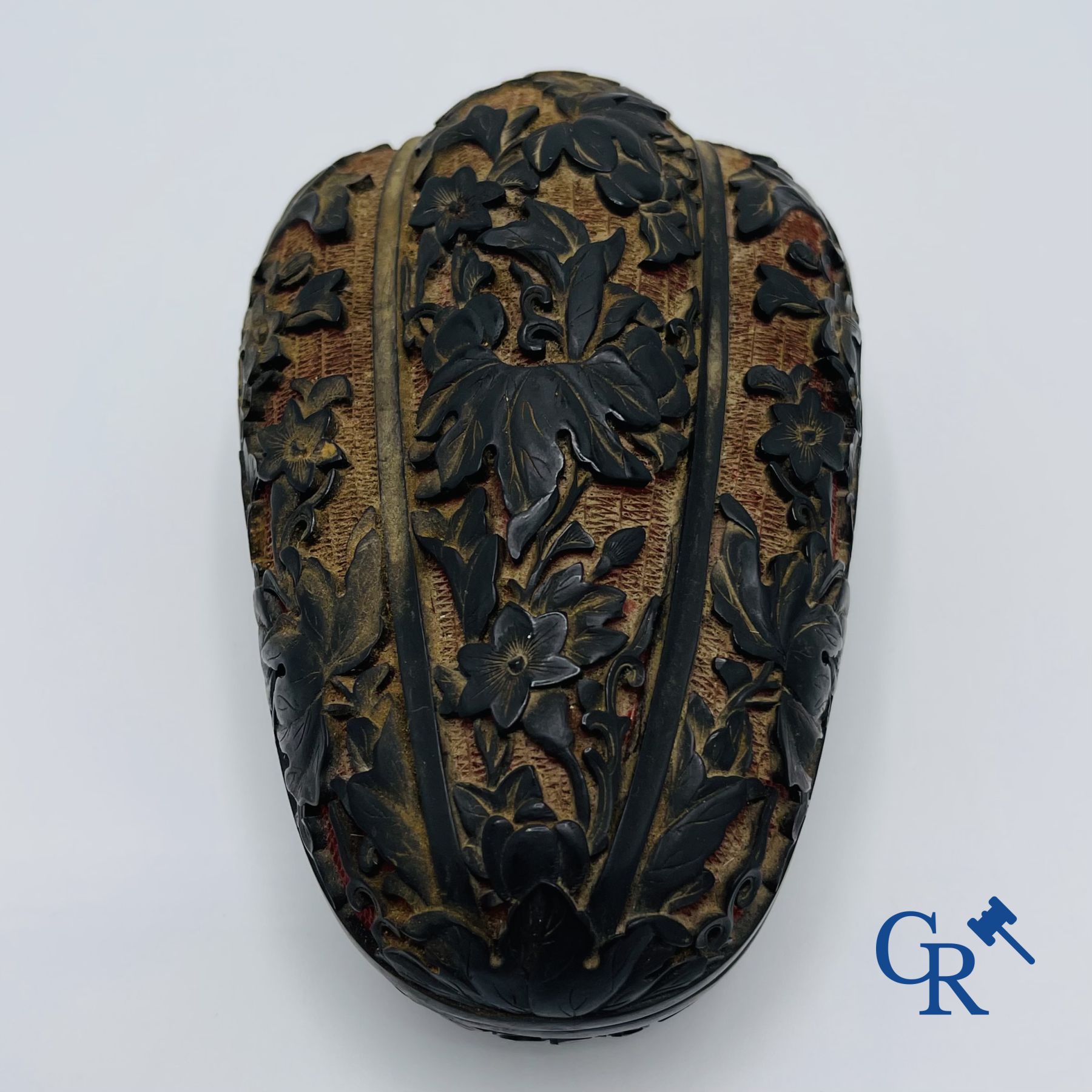 Asian Art: A finely carved Chinese lid box in black lacquer on a red background.