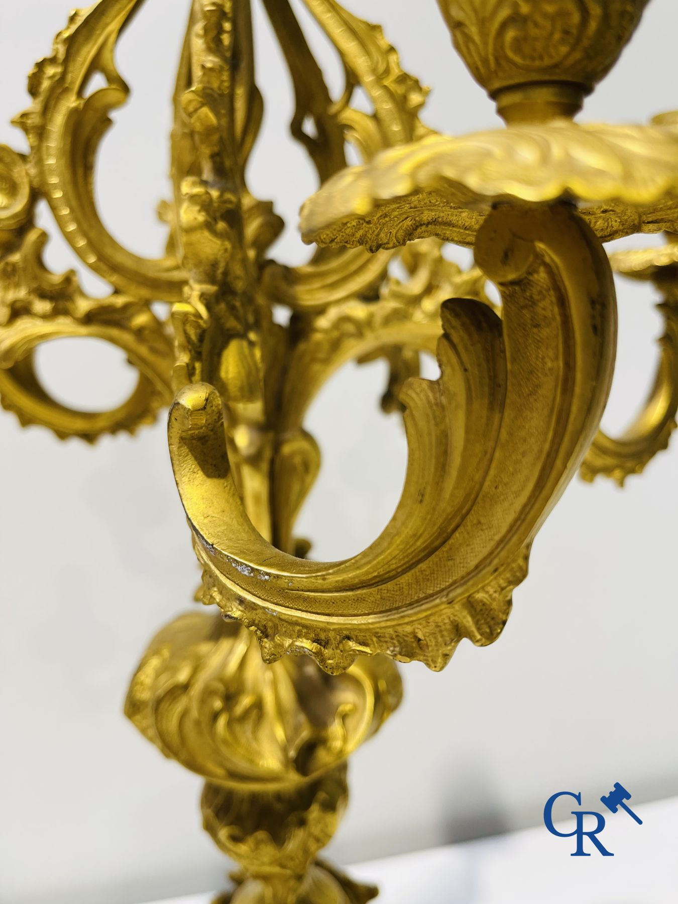 A large 3-piece fire-gilded bronze chimney set in LV style. 19th century.