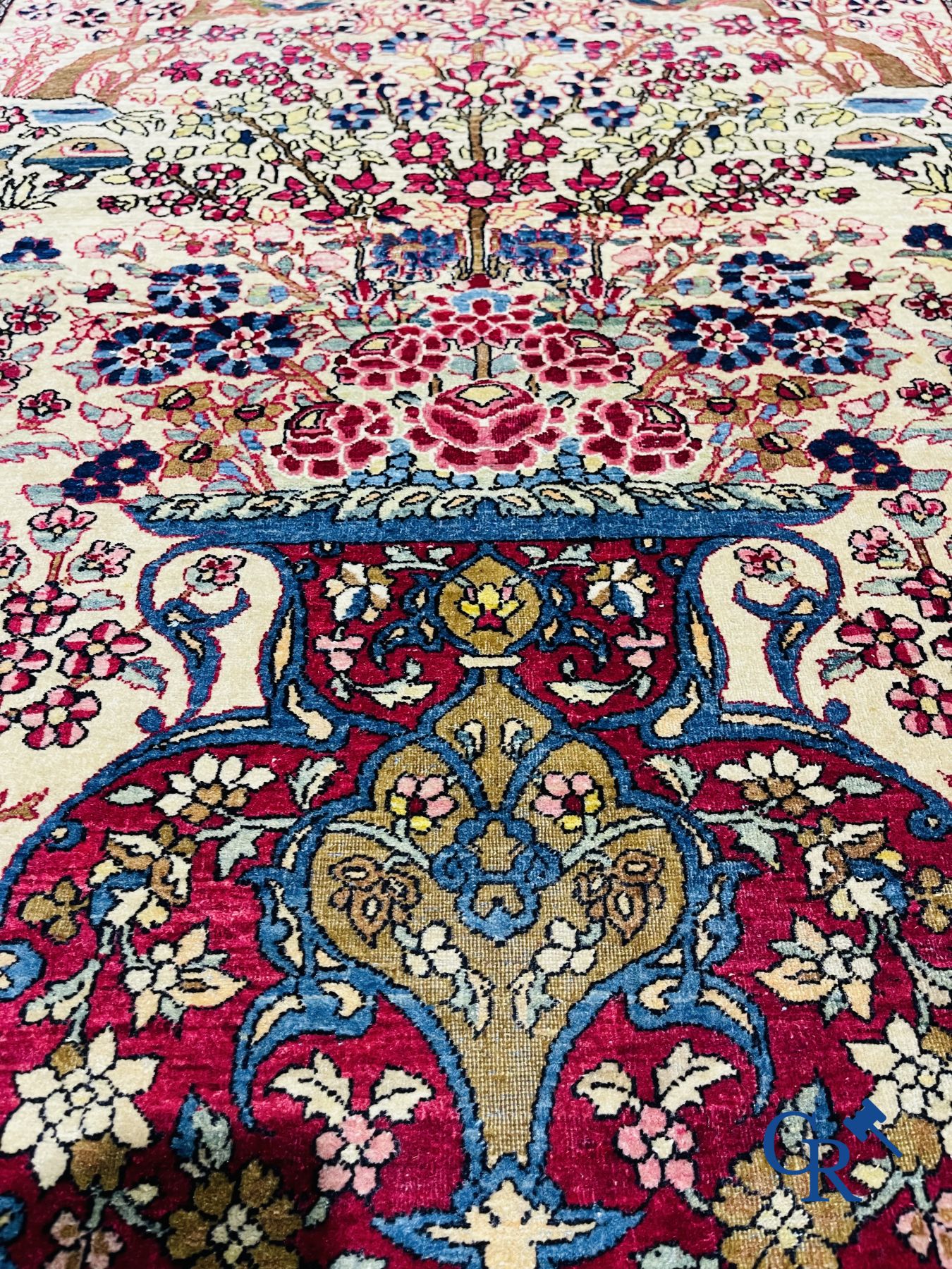 Oriental carpets. Iran. Persian carpet with a flower vase, birds and rabbits in a floral decor.