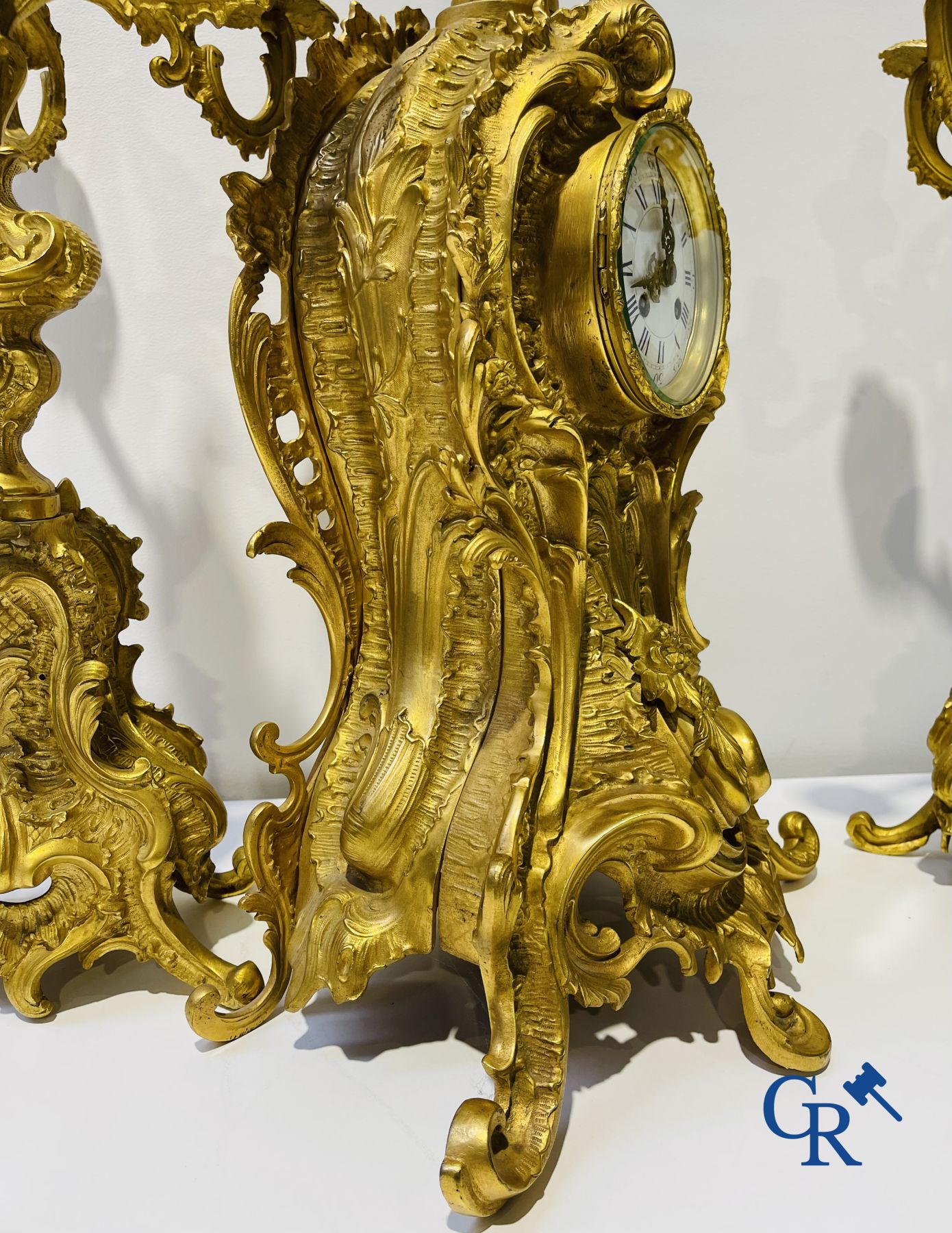 A large 3-piece fire-gilded bronze chimney set in LV style. 19th century.