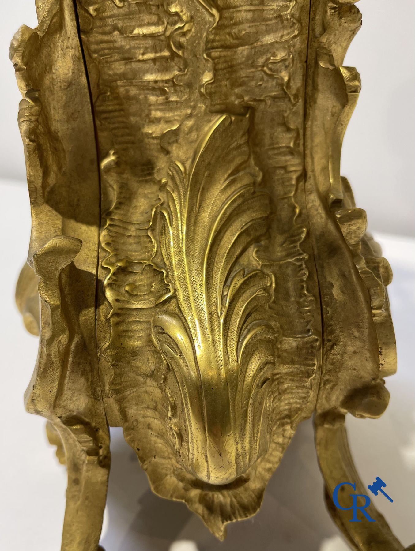 A large 3-piece fire-gilded bronze chimney set in LV style. 19th century.