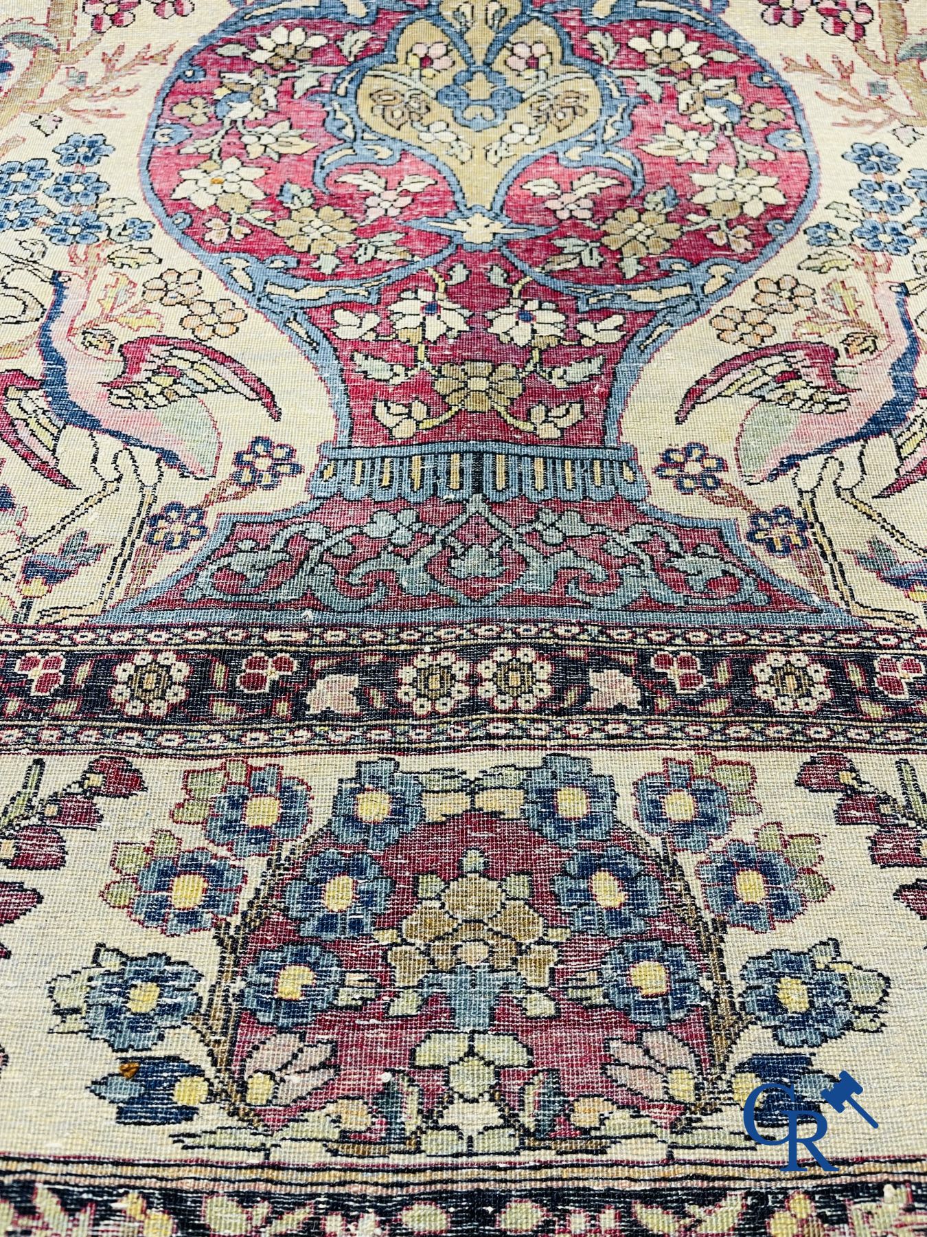 Oriental carpets. Iran. Persian carpet with a flower vase, birds and rabbits in a floral decor.