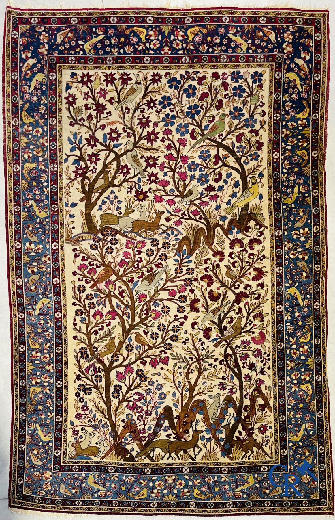 Oriental carpets: Antique oriental carpet with a decor of animals and birds in the forest.