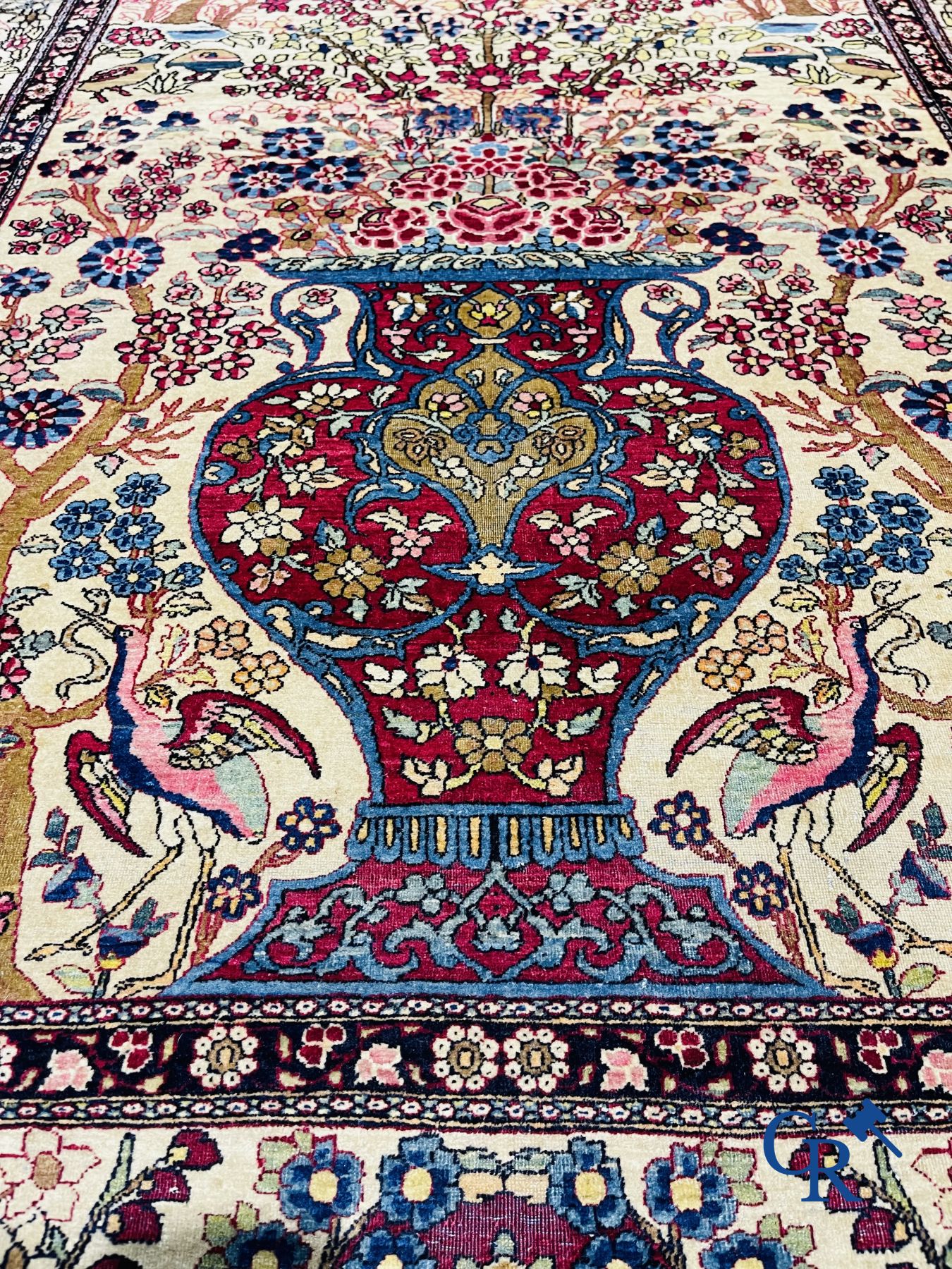 Oriental carpets. Iran. Persian carpet with a flower vase, birds and rabbits in a floral decor.