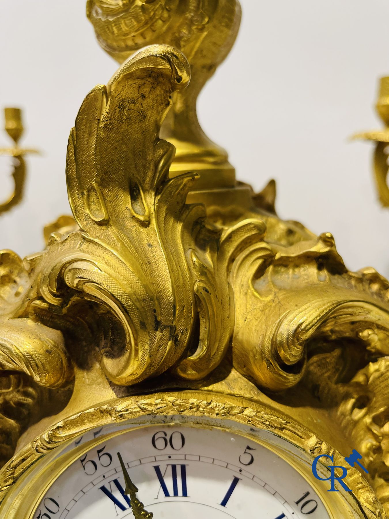 A large 3-piece fire-gilded bronze chimney set in LV style. 19th century.