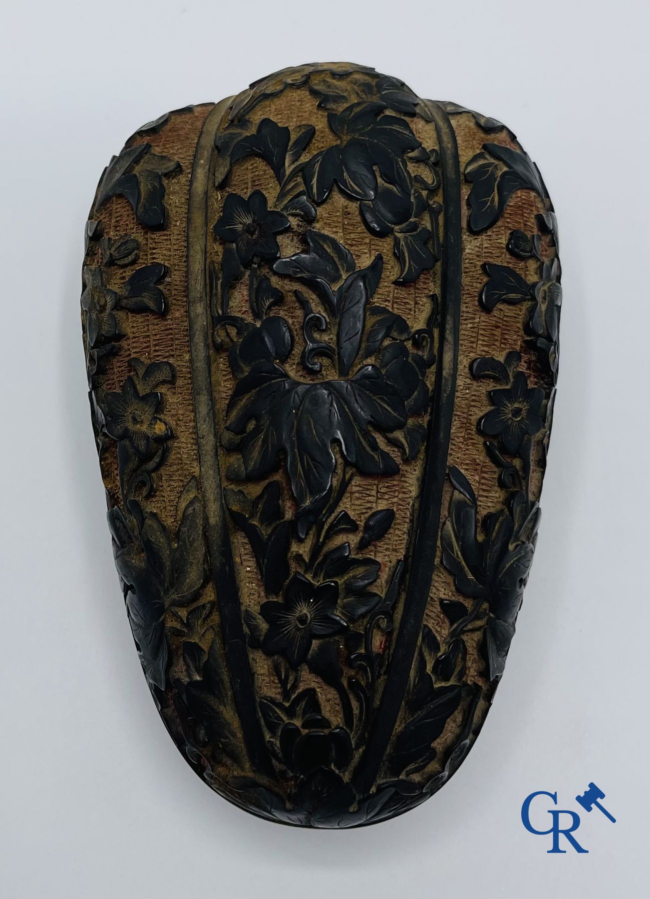 Asian Art: A finely carved Chinese lid box in black lacquer on a red background.