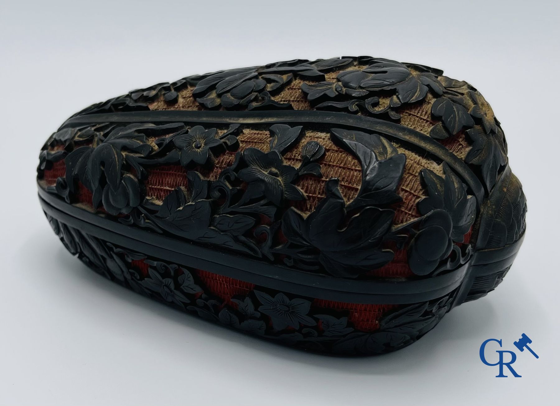 Asian Art: A finely carved Chinese lid box in black lacquer on a red background.