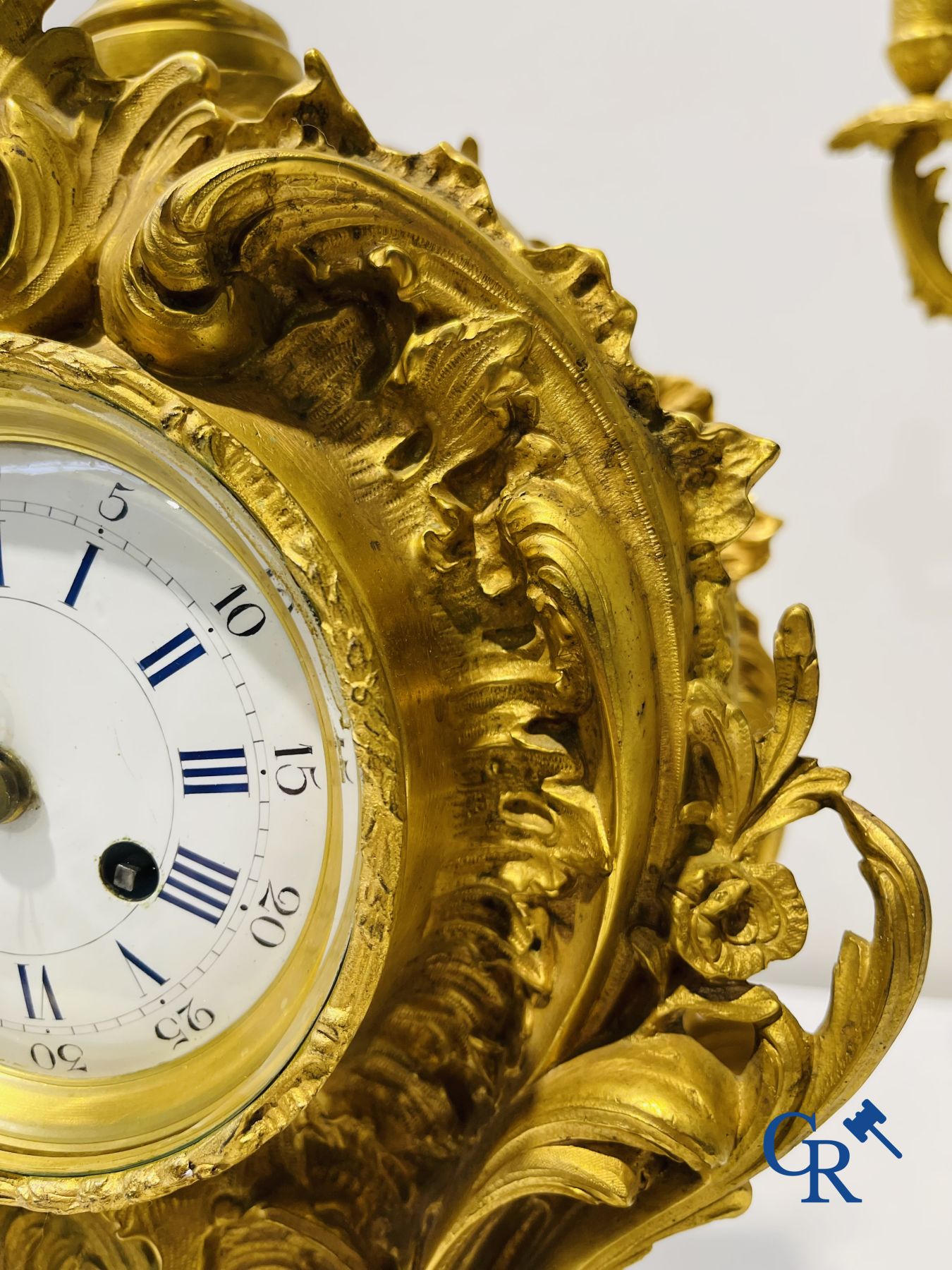 A large 3-piece fire-gilded bronze chimney set in LV style. 19th century.