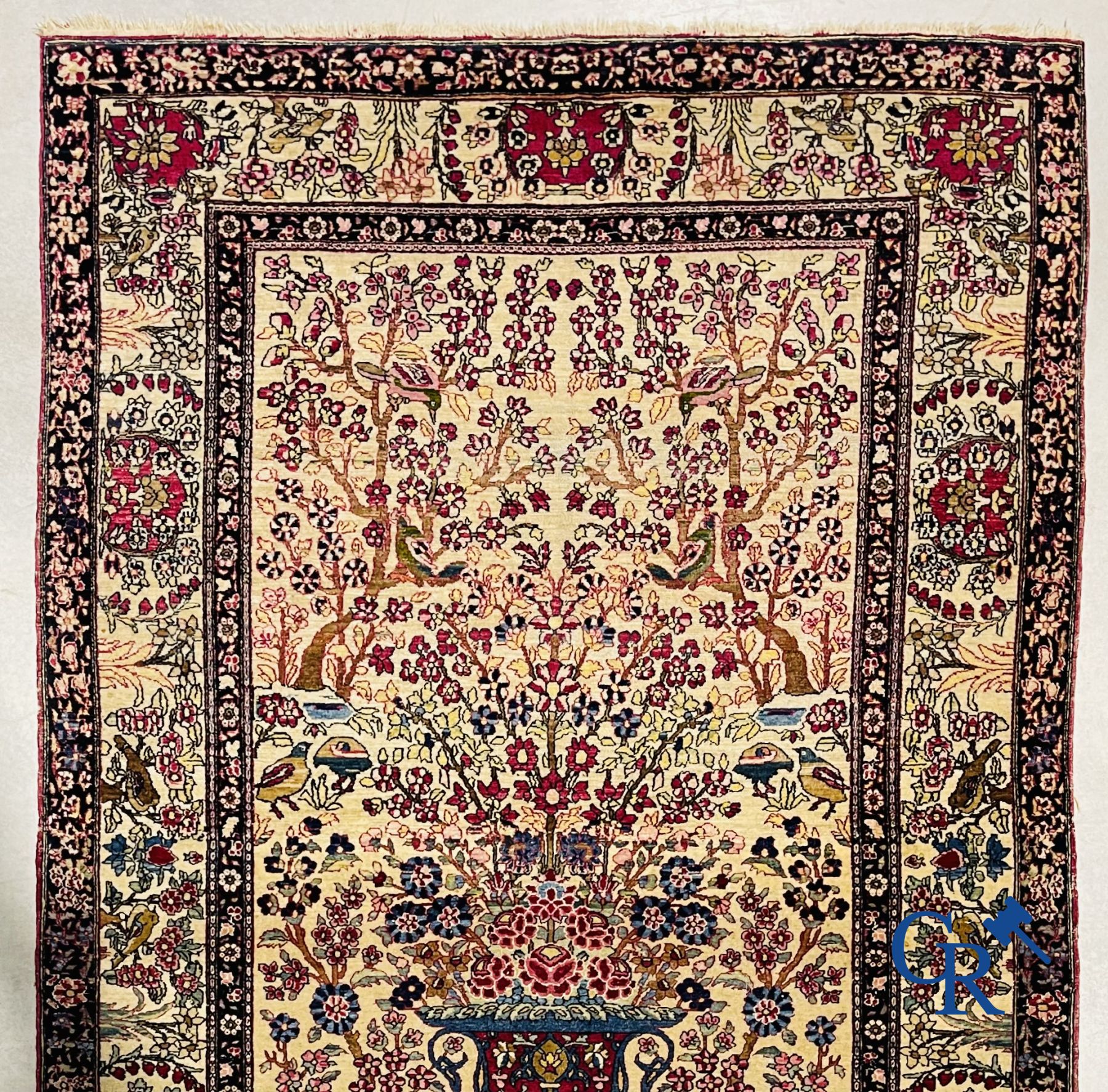 Oriental carpets. Iran. Persian carpet with a flower vase, birds and rabbits in a floral decor.