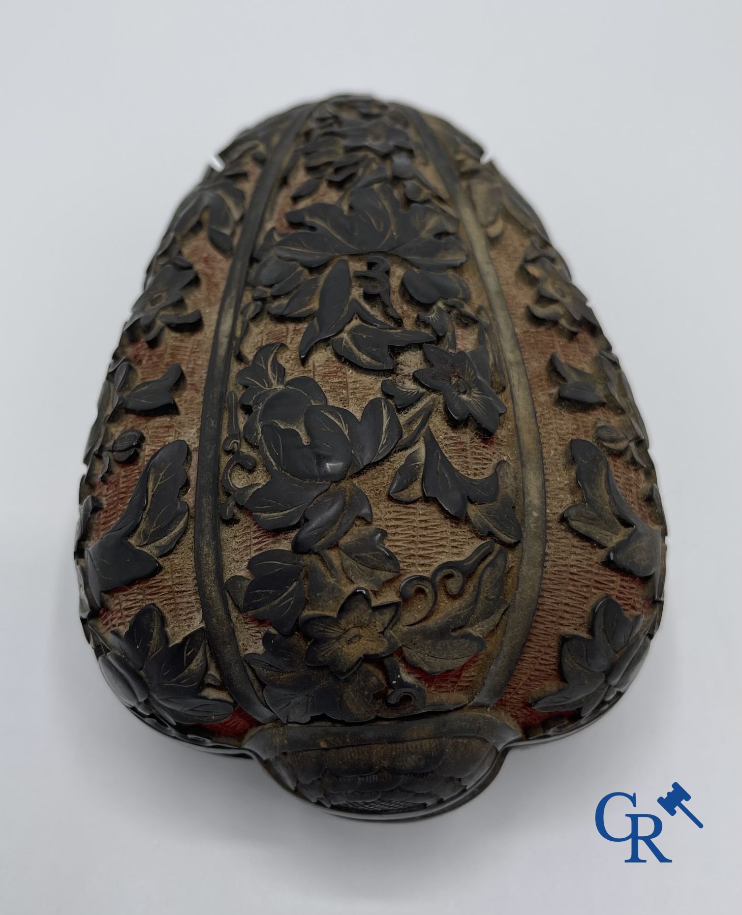 Asian Art: A finely carved Chinese lid box in black lacquer on a red background.