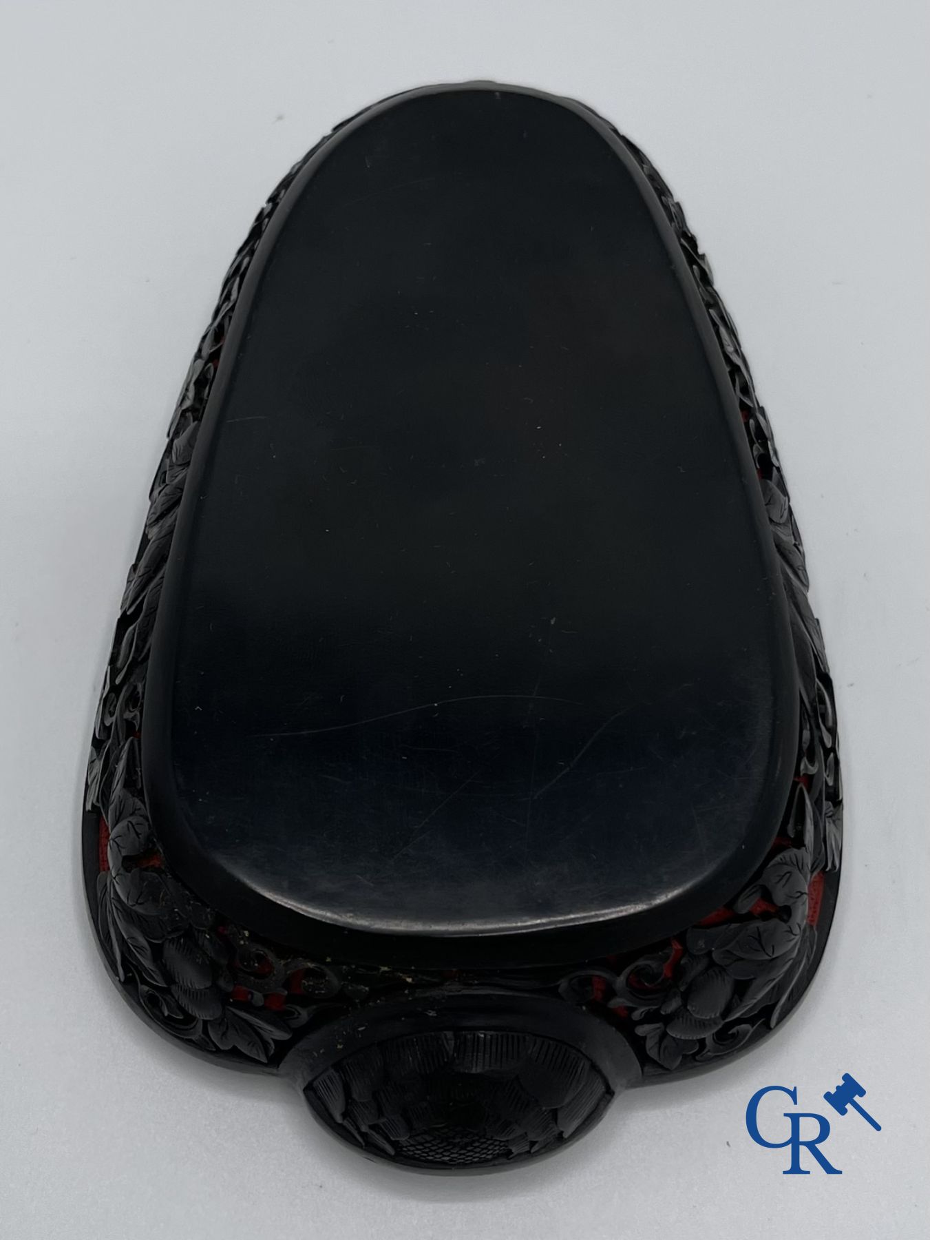 Asian Art: A finely carved Chinese lid box in black lacquer on a red background.