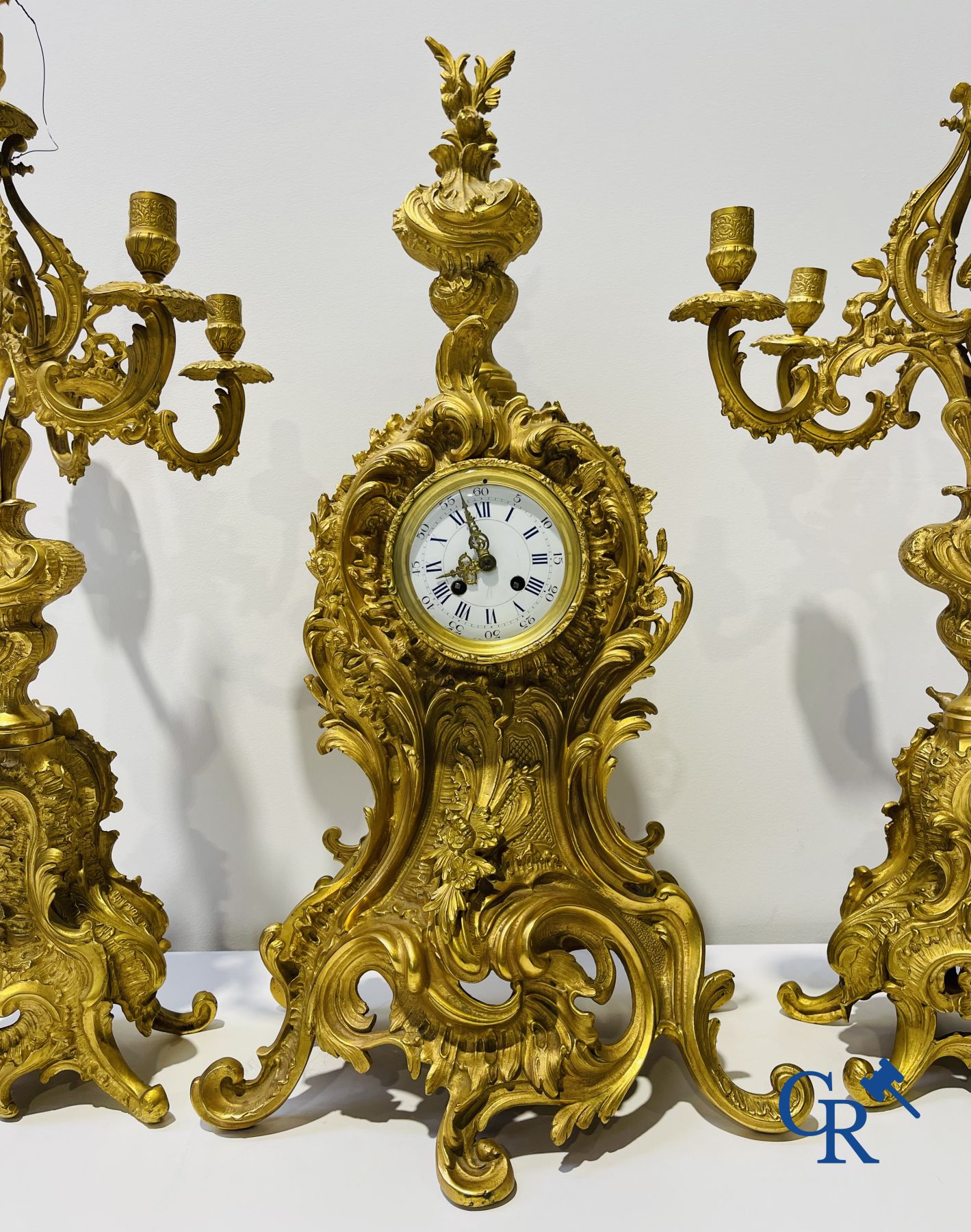 A large 3-piece fire-gilded bronze chimney set in LV style. 19th century.