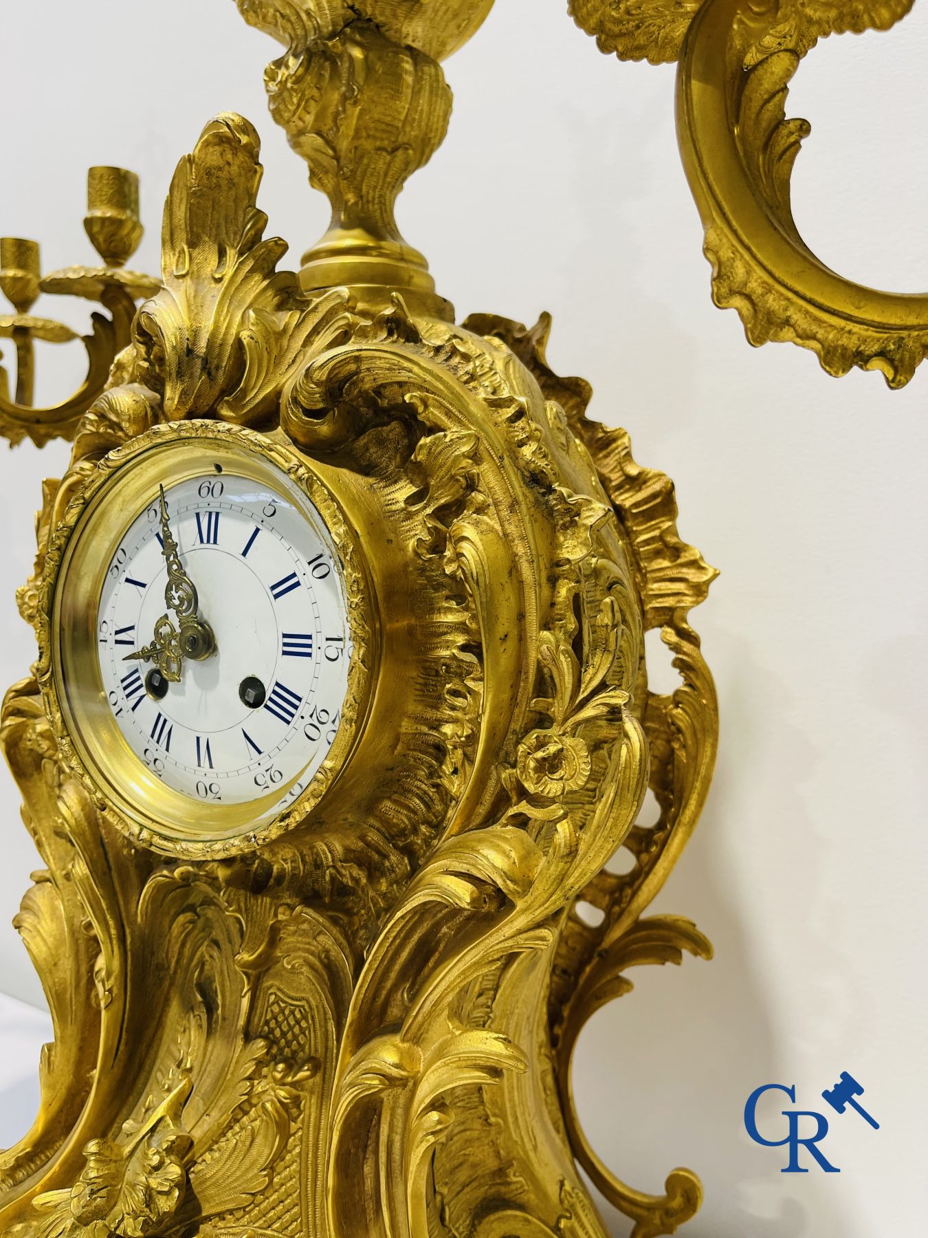 A large 3-piece fire-gilded bronze chimney set in LV style. 19th century.